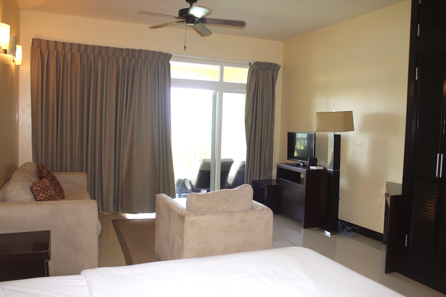 Sitting area adjacent to the bed in the Ocean's Edge One Bedroom Studio For Sale St. Kitts