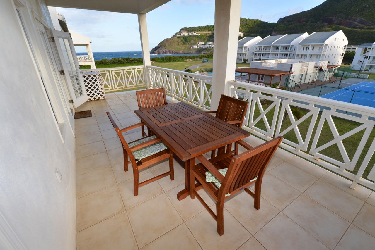 Balcony with views of the pool and partial view of the Atlantic ocean 
