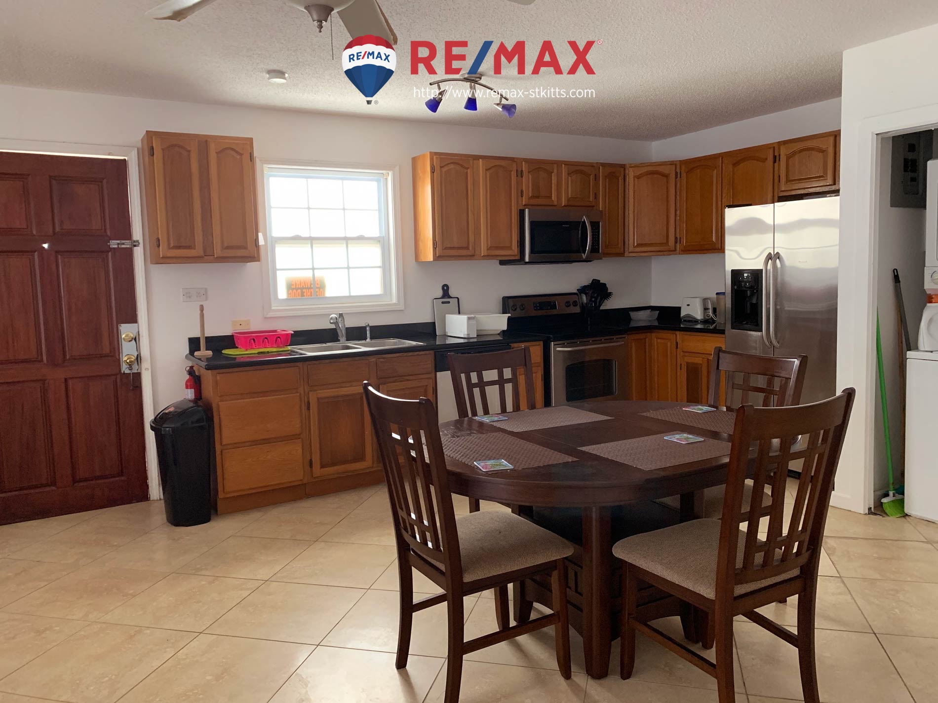 Living room and kitchen of 2 bedroom citizenship approved condo for sale st. kitts